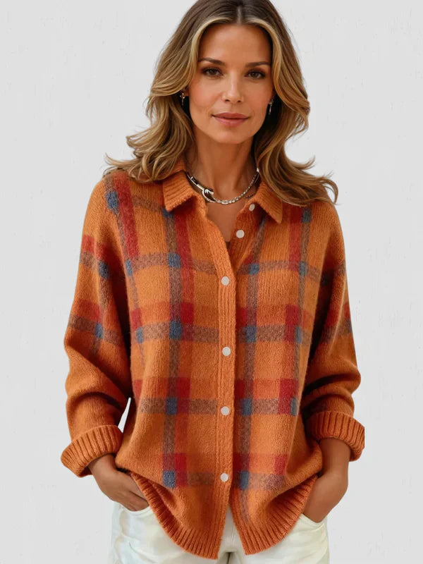 Burnt orange plaid knit cardigan with button front and relaxed fit, worn with sleeves rolled up.
