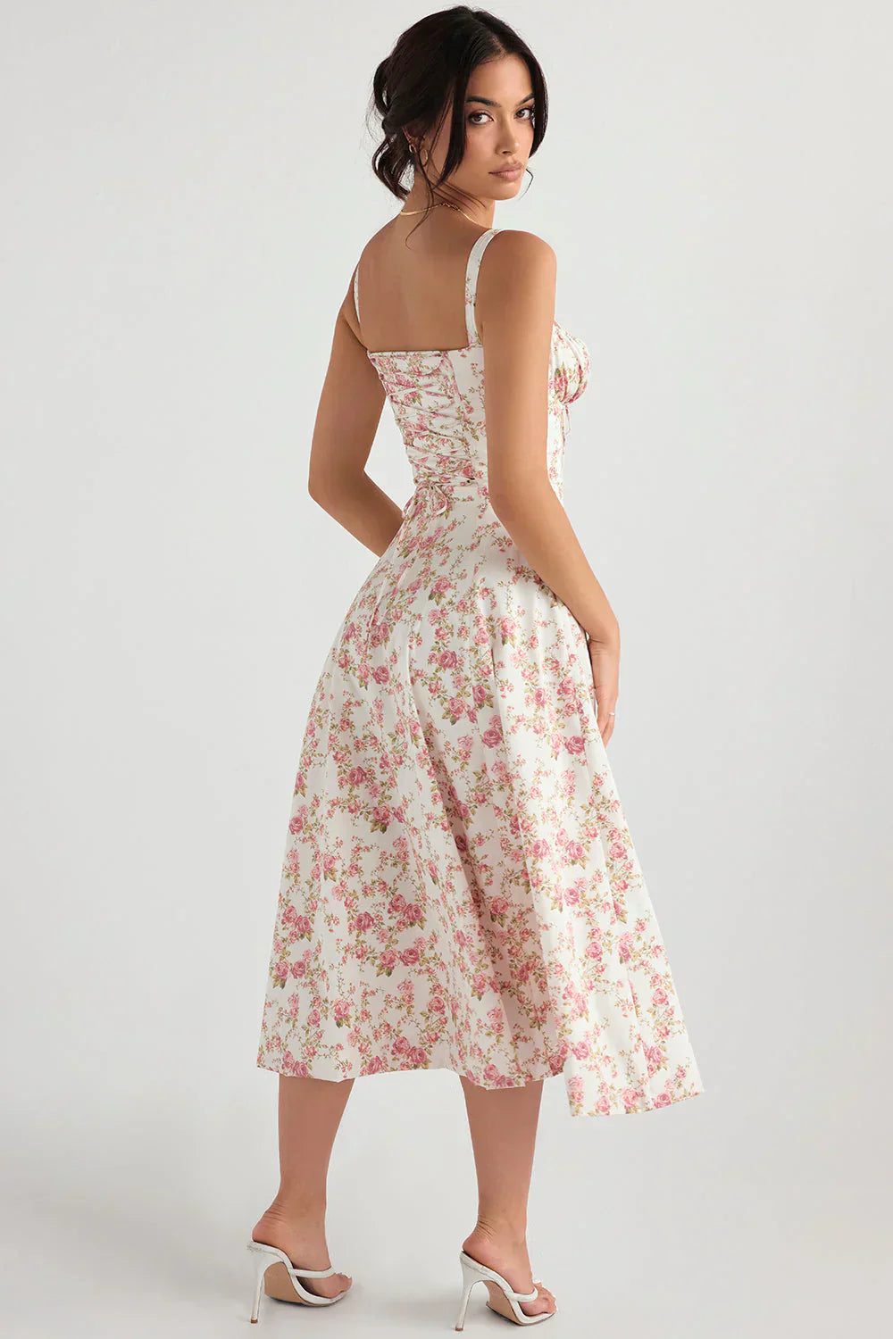 Woman wearing a floral dress on a white background