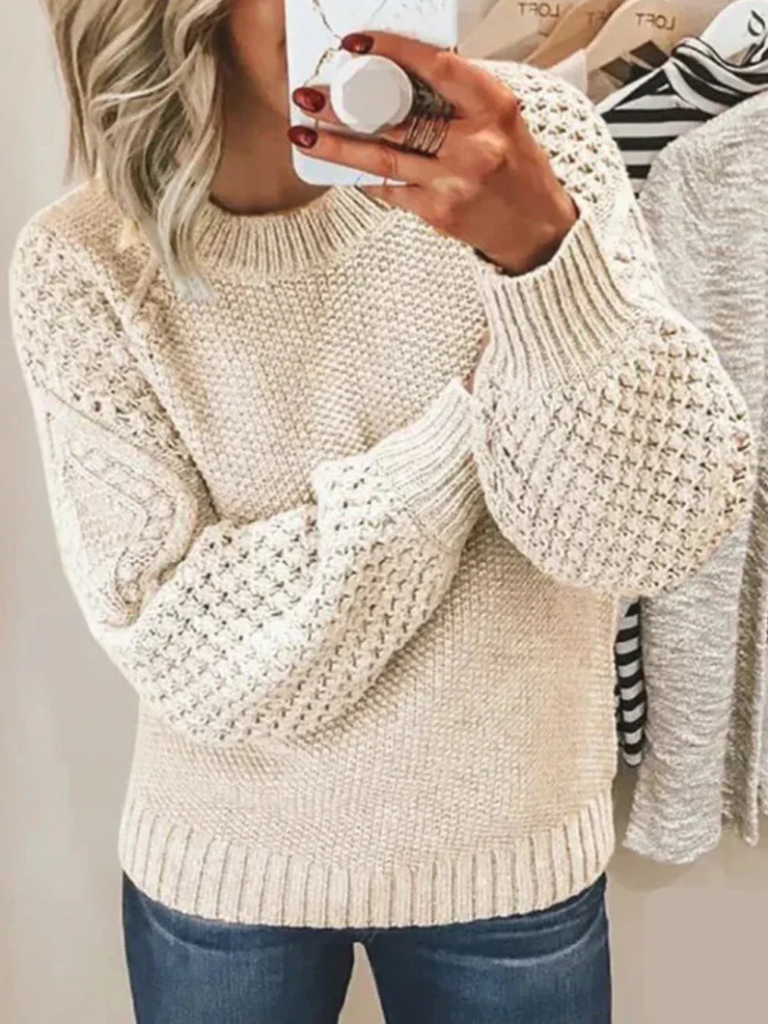 Beige chunky knit sweater with textured sleeves and ribbed cuffs and hem.