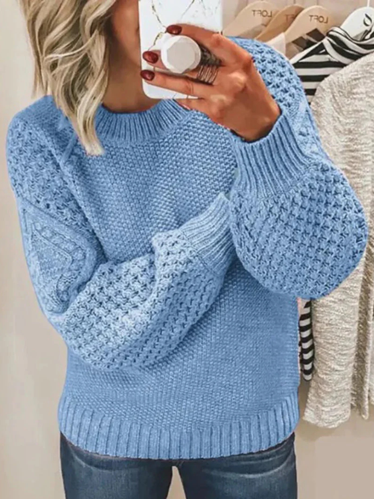 Light blue knitted sweater with textured bubble sleeves and ribbed hem and cuffs.