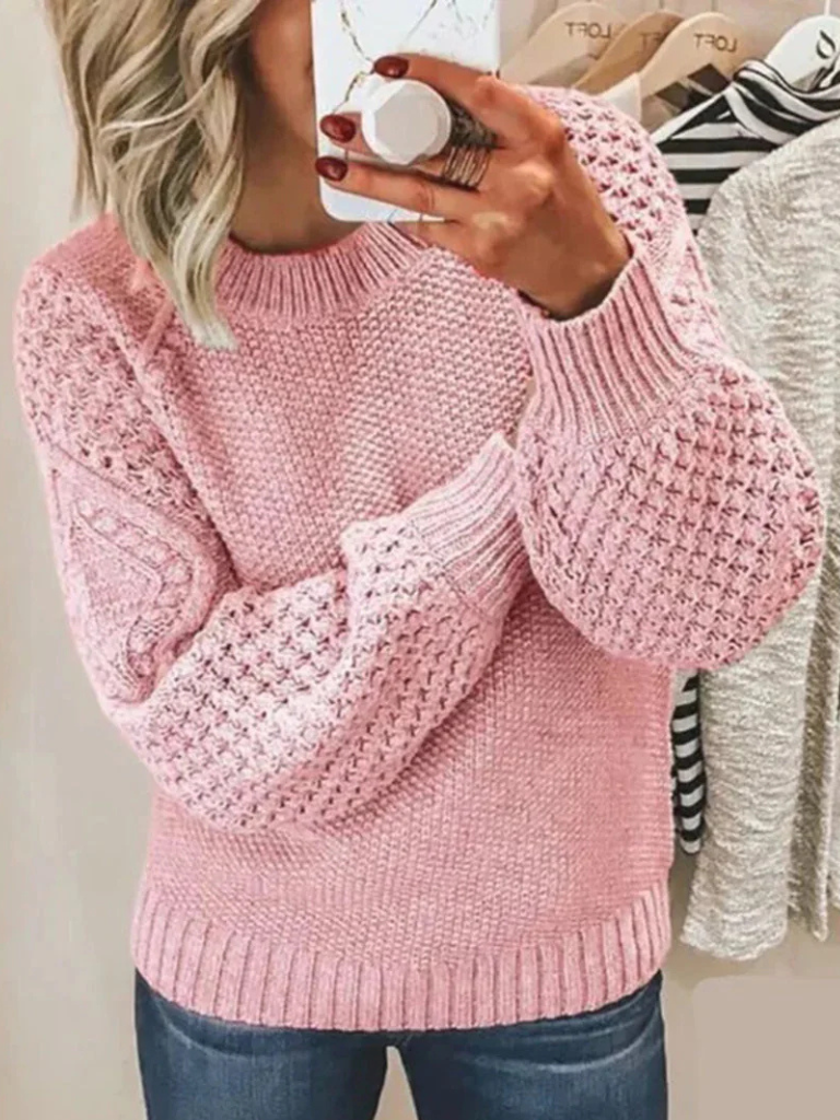 Soft pink knit sweater with textured bubble sleeves and ribbed cuffs and hem.
