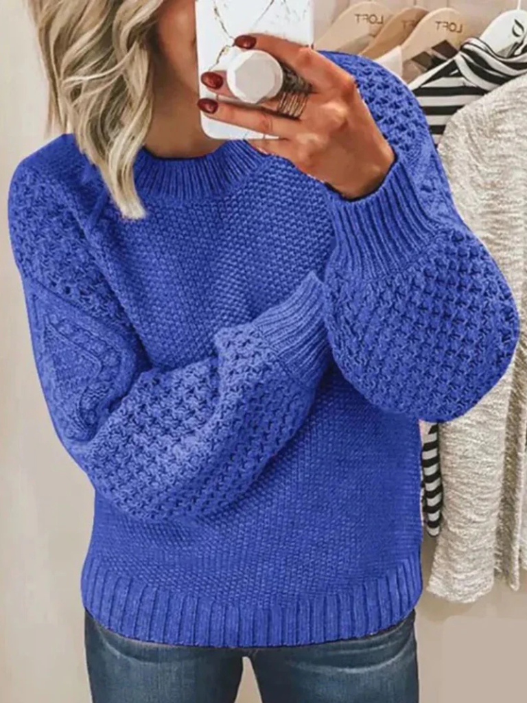 Blue soft knit sweater with textured balloon sleeves and ribbed cuffs and hem.