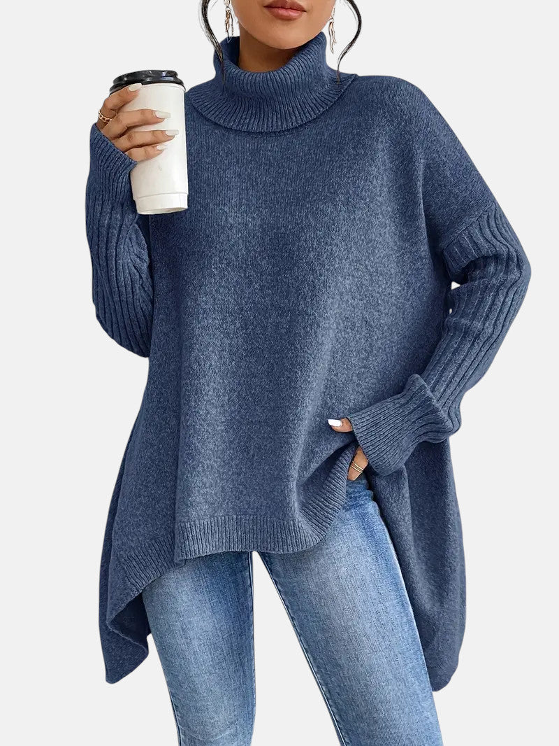Steel blue long turtleneck sweater with relaxed fit and ribbed sleeve cuffs worn with jeans.