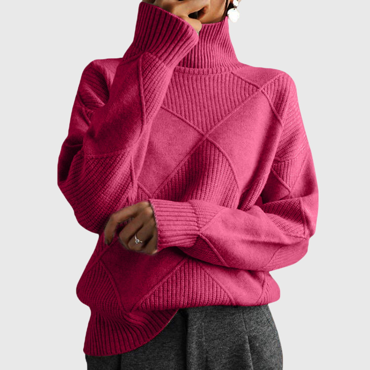 Dusty rose turtleneck sweater with ribbed knit texture and geometric pattern.