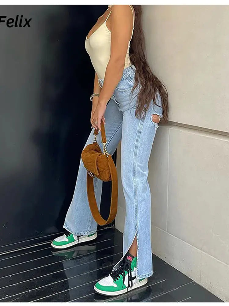 Women's blue ripped jeans — split hem detail