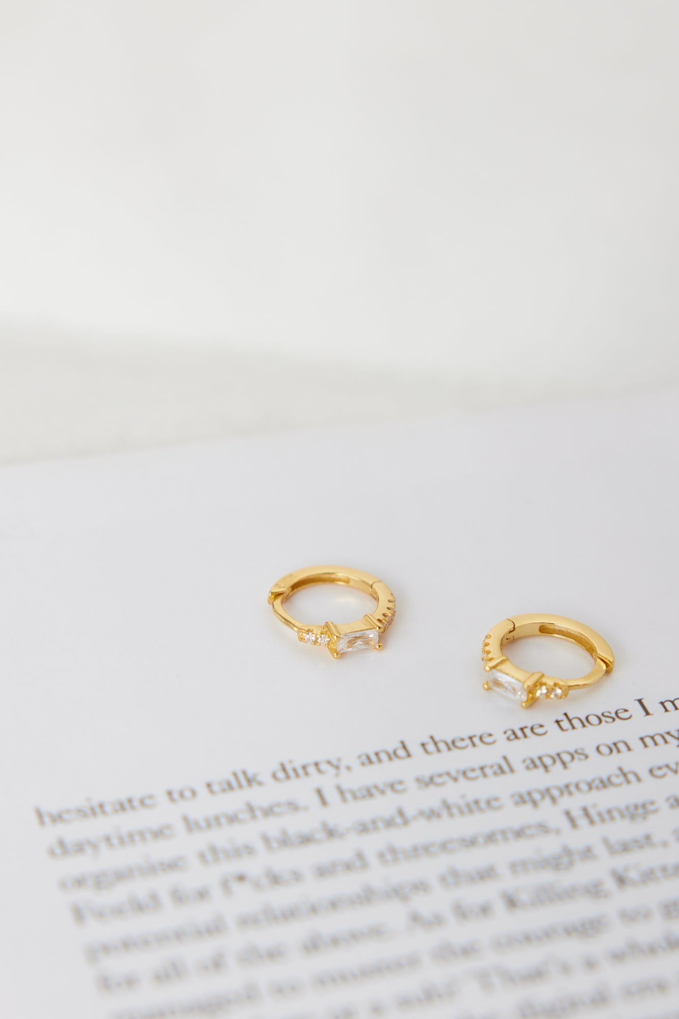 Women's gold cubic zirconia hoop earrings — detail shot