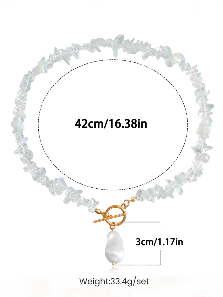 Women's gold coral chip and pearl necklace — close-up detail