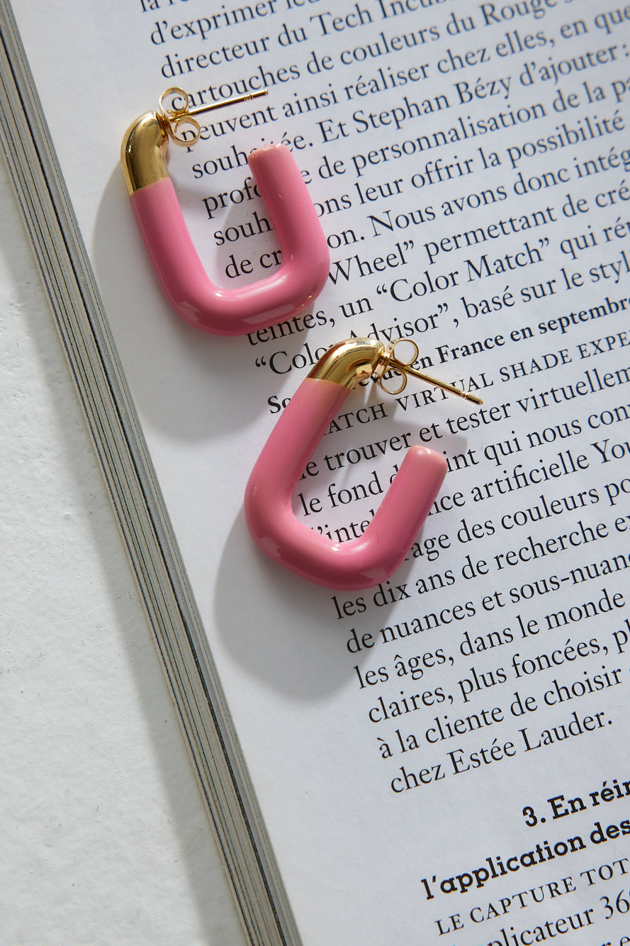 Women's gold-plated pink hoop earrings — worn detail
