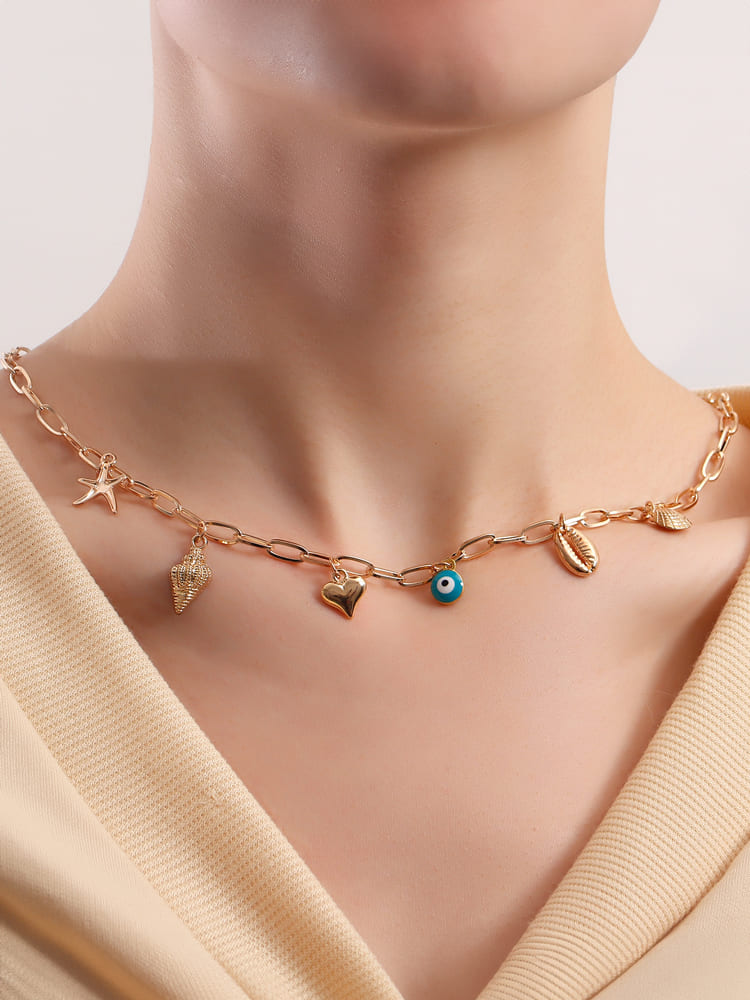 Women's gold spiral shell and seastar necklace