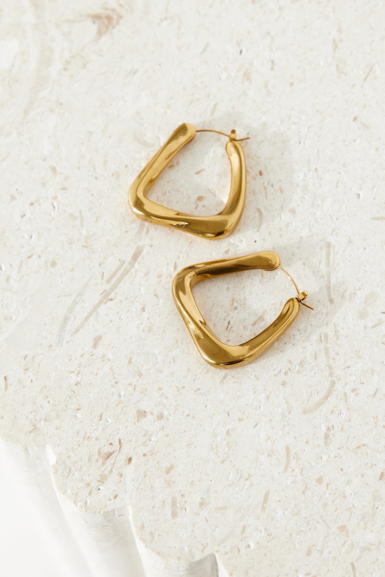 Women's gold statement hoop earrings — alternate angle