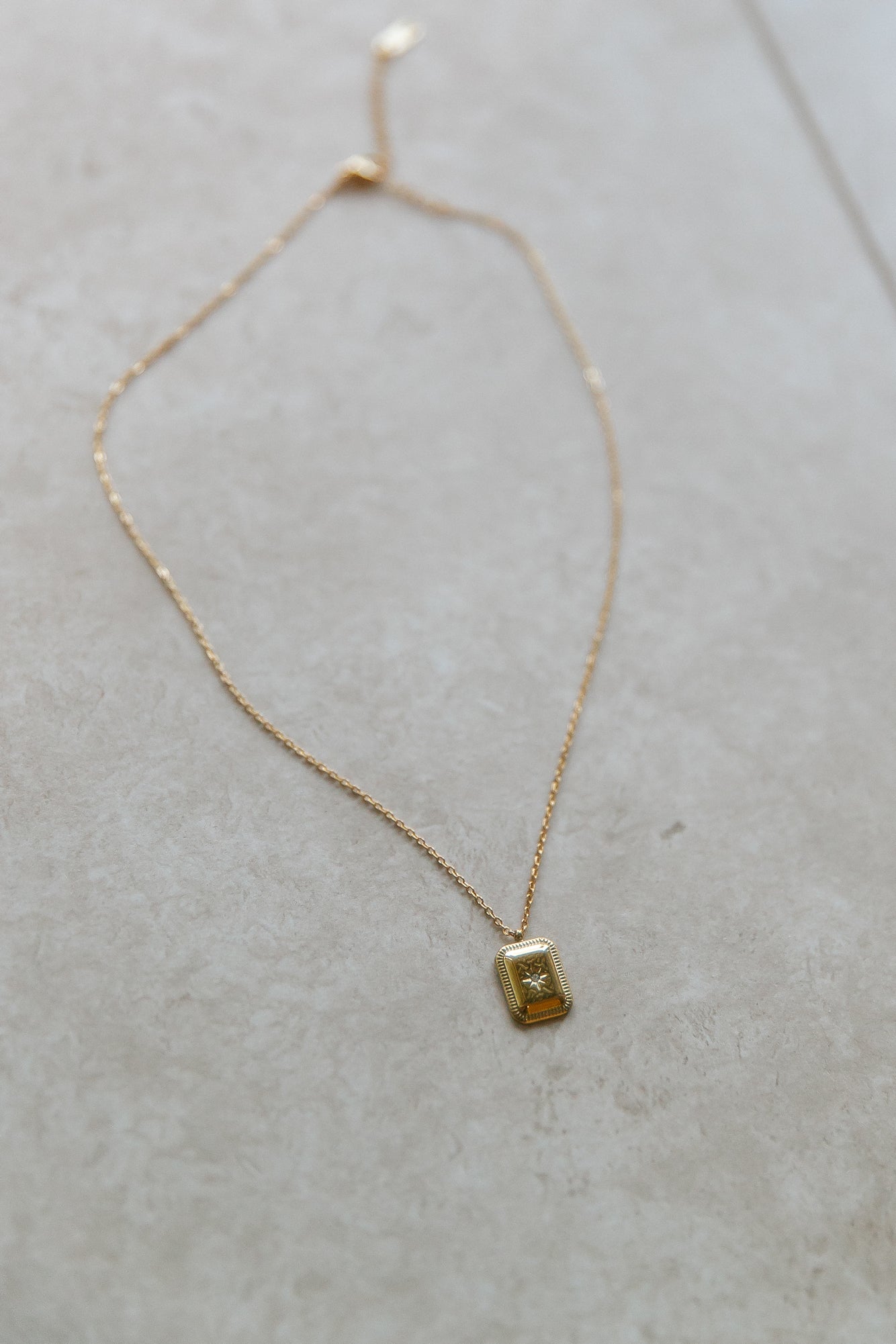 Women's gold thin chain pendant necklace — detail view