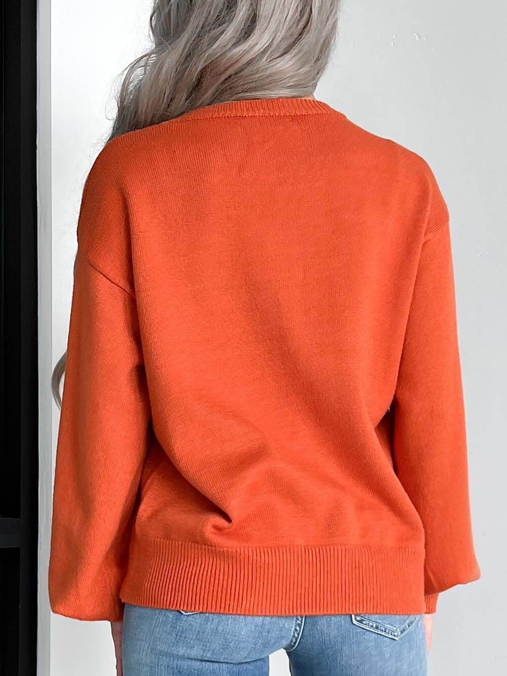 Women's orange pumpkin carving knit Halloween sweater — fabric detail