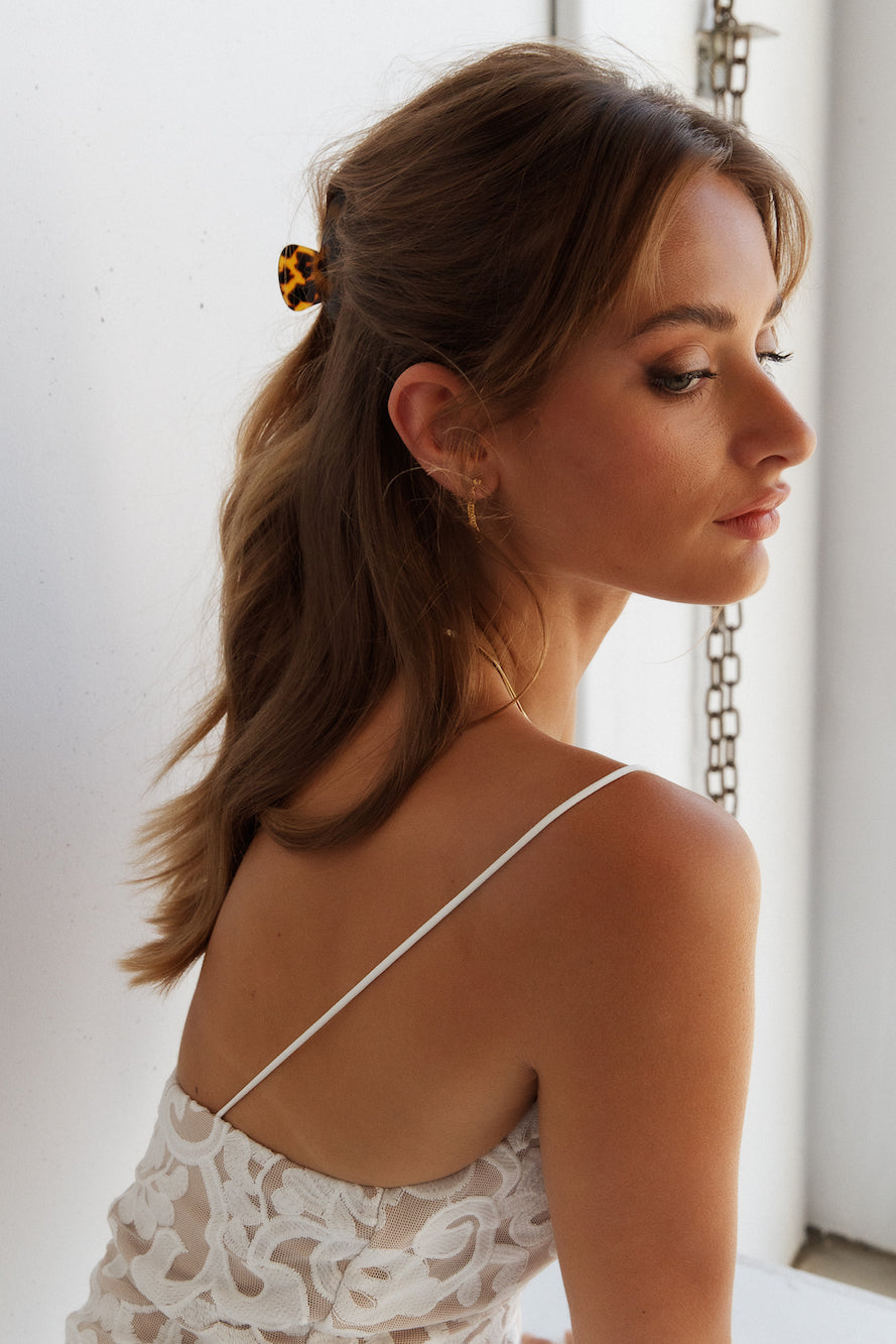 Women's gold zirconia stud earrings — detail shot