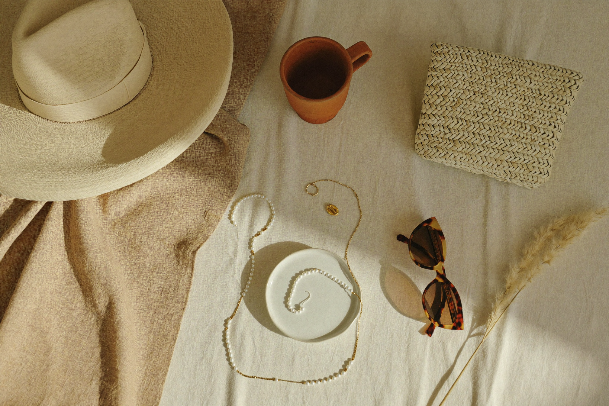 How to style a co-ord set — summer styling essentials flat lay with straw hat, woven bag and gold jewellery