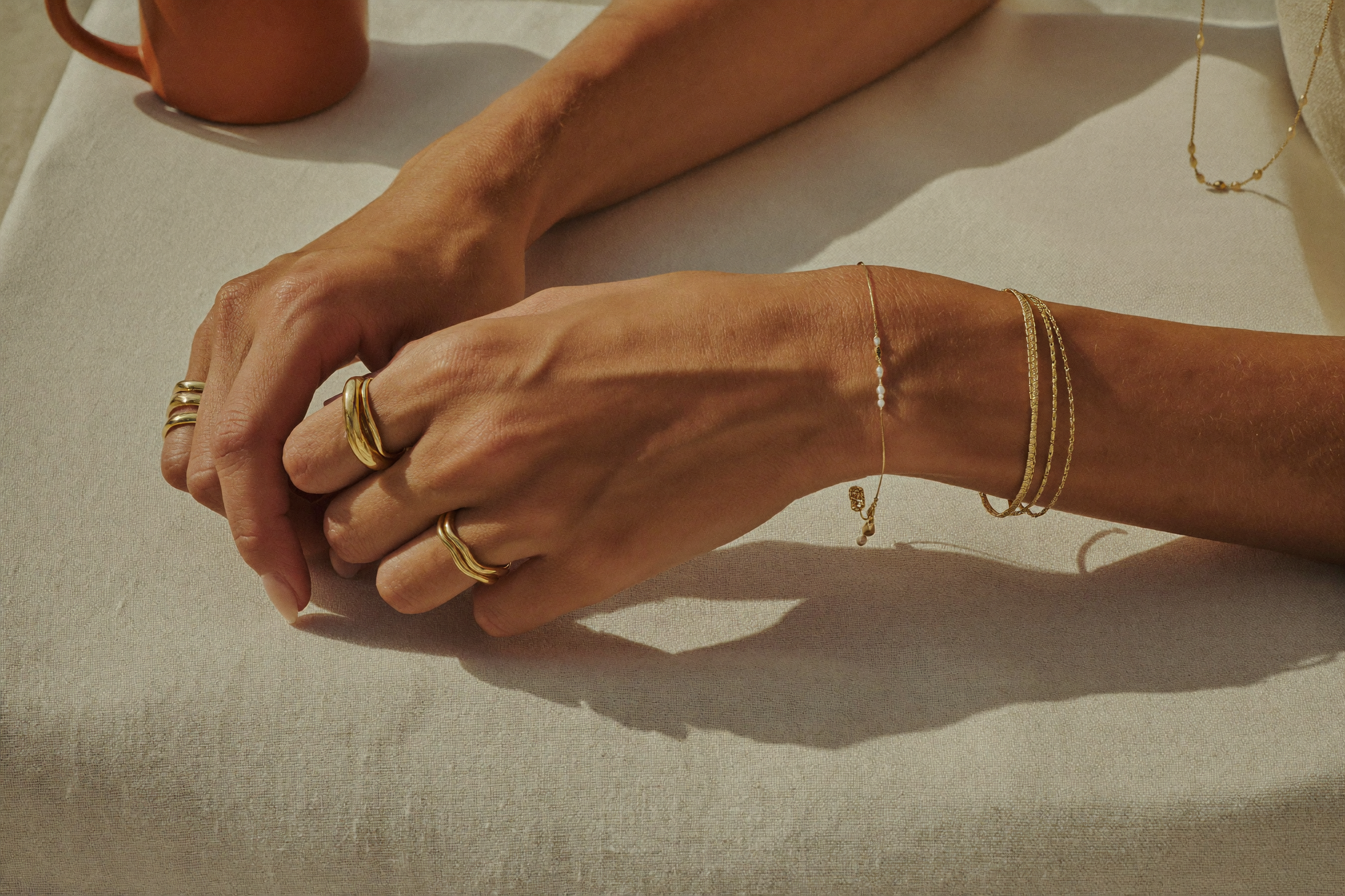 Layered gold rings, bracelets and necklaces — how to stack gold jewellery