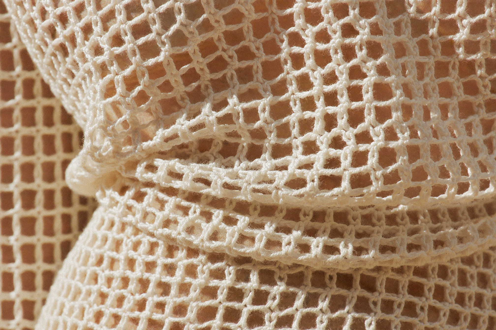 Ivory open-knit crochet fabric texture, the crochet trend for summer 2026