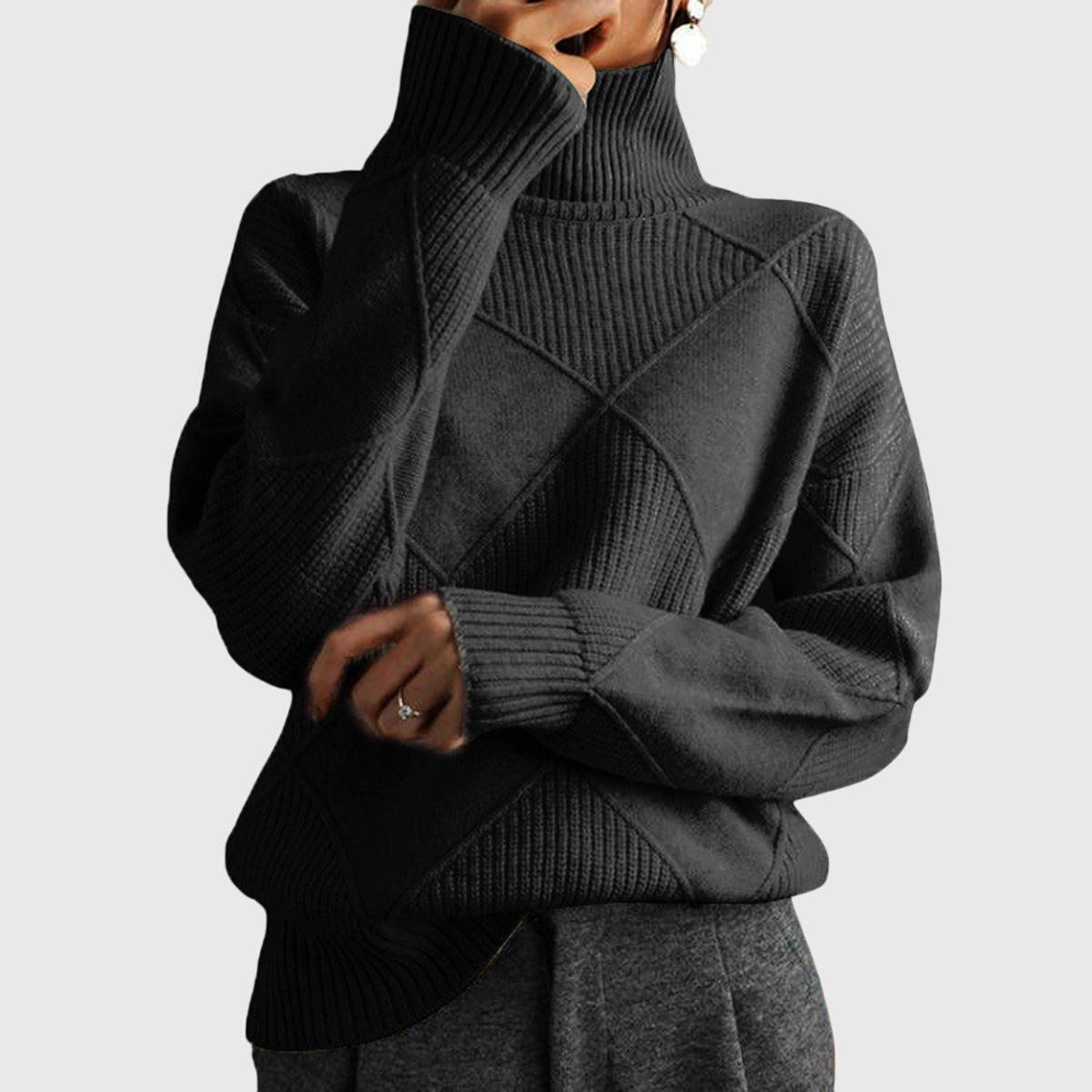 Charcoal gray turtleneck sweater with geometric knit patterns and ribbed cuffs and hem.
