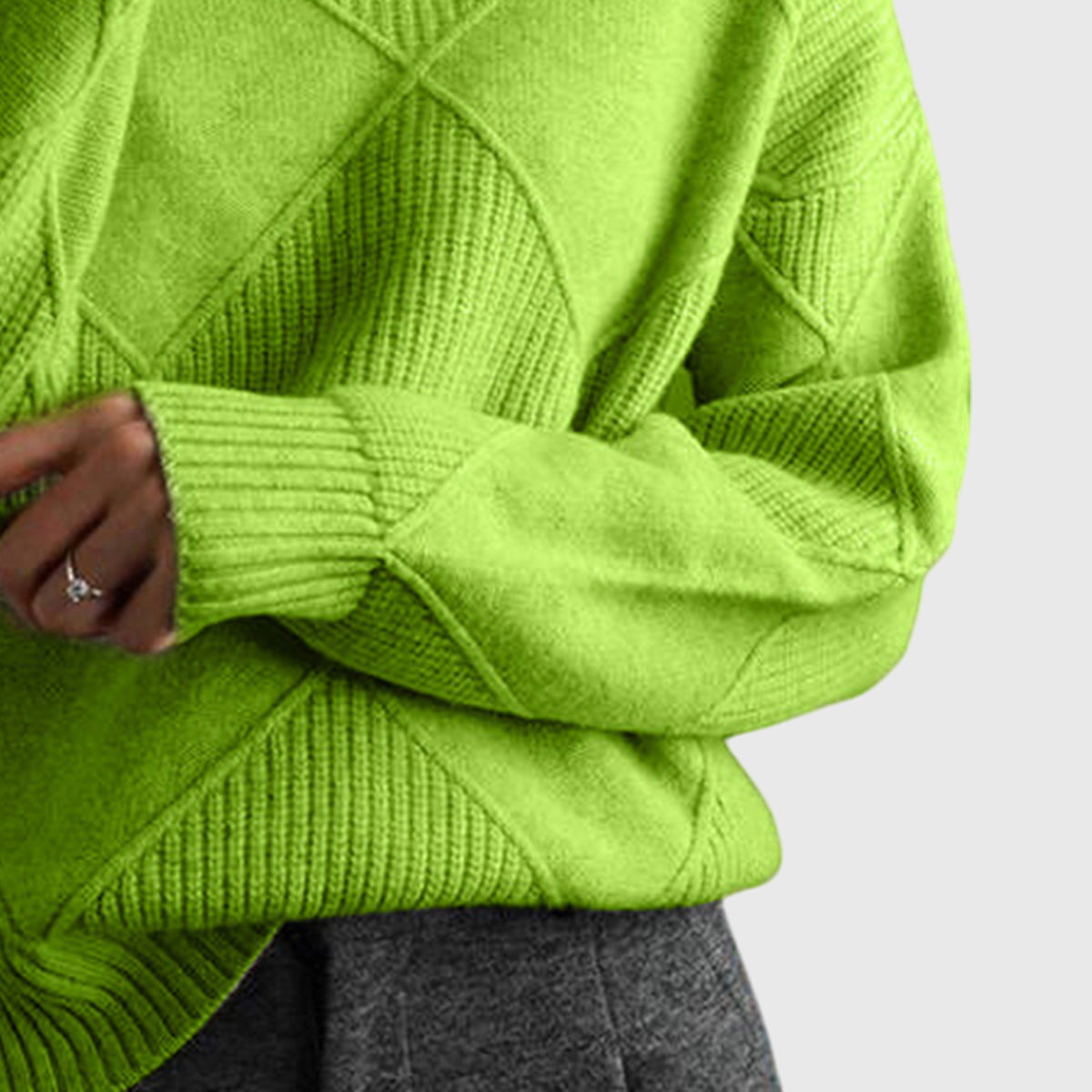 Bright green turtleneck sweater with textured diagonal and square knit patterns and ribbed cuffs.