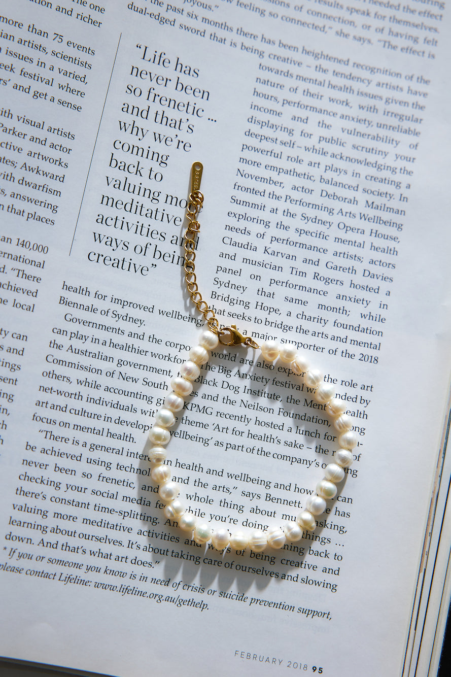Women's gold pearl charm bracelet