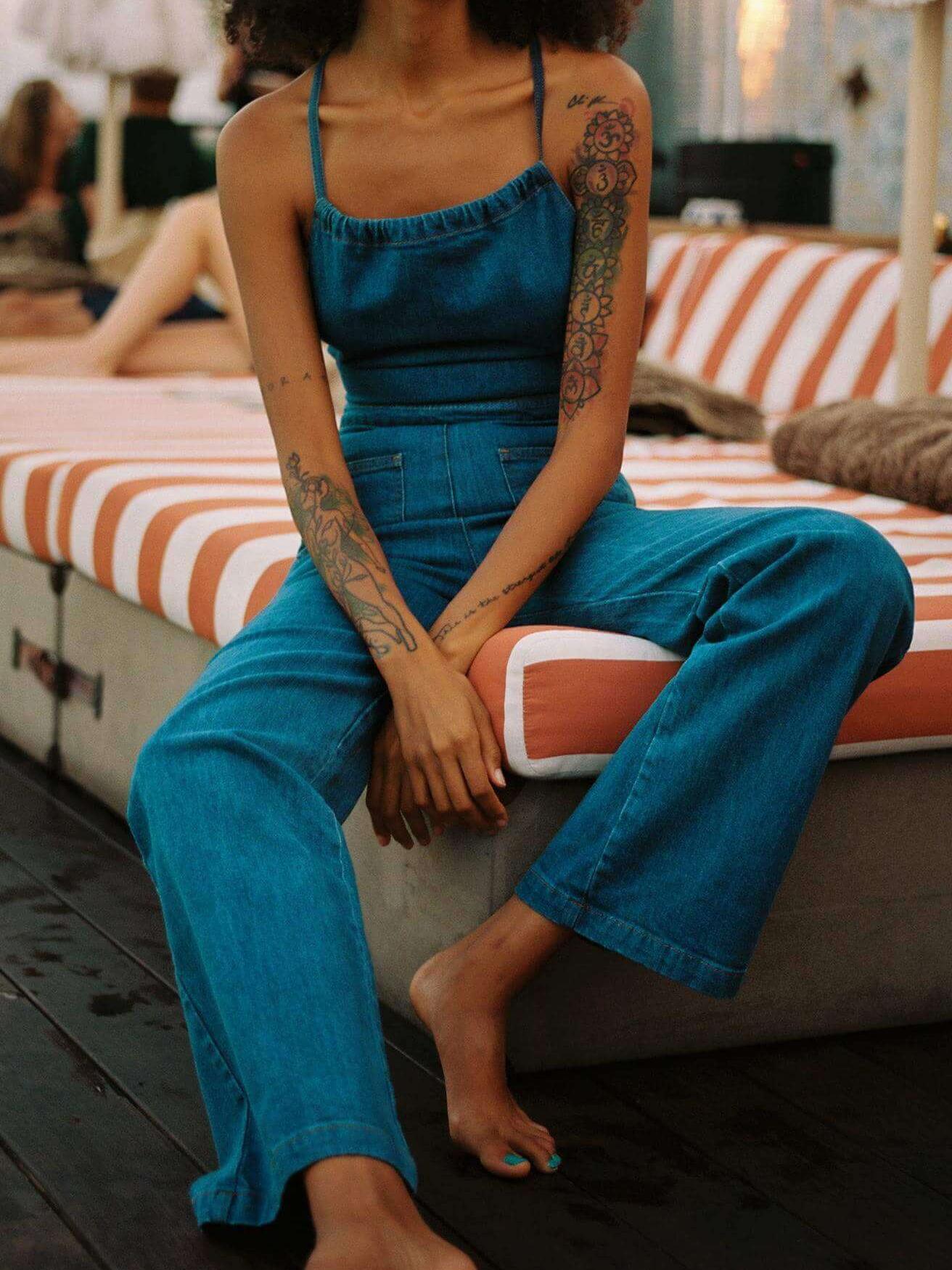 Women's blue flared denim tie-back jumpsuit — back view