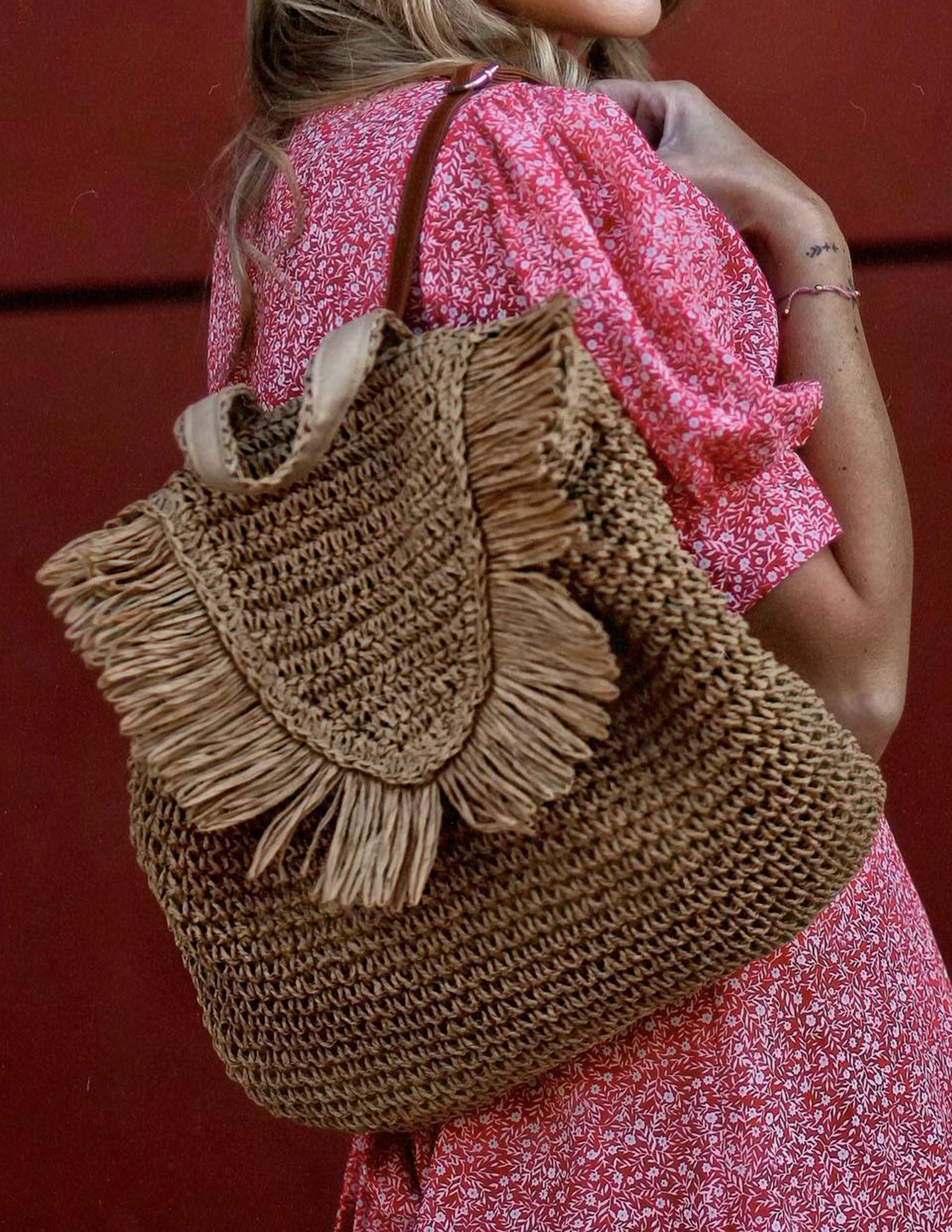Women's brown fringed woven straw backpack