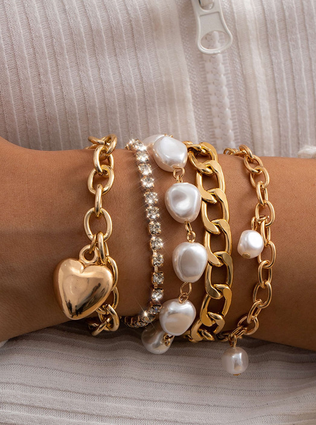 Women's gold chain and pearl layered bracelet — detail
