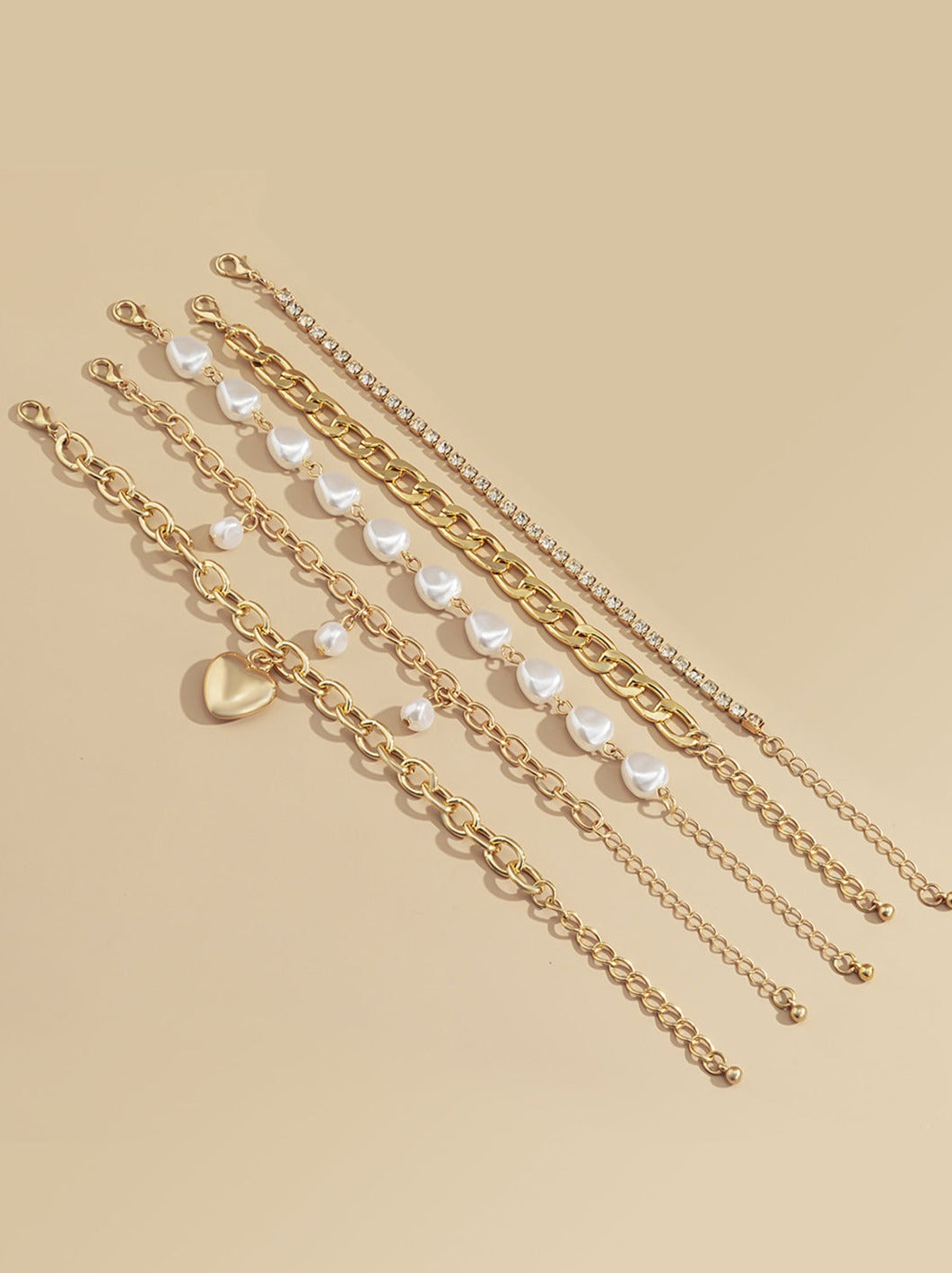 Women's gold chain and pearl layered bracelet — detail