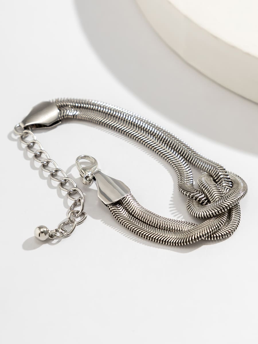 Women's coiled snake chain bracelet — worn view