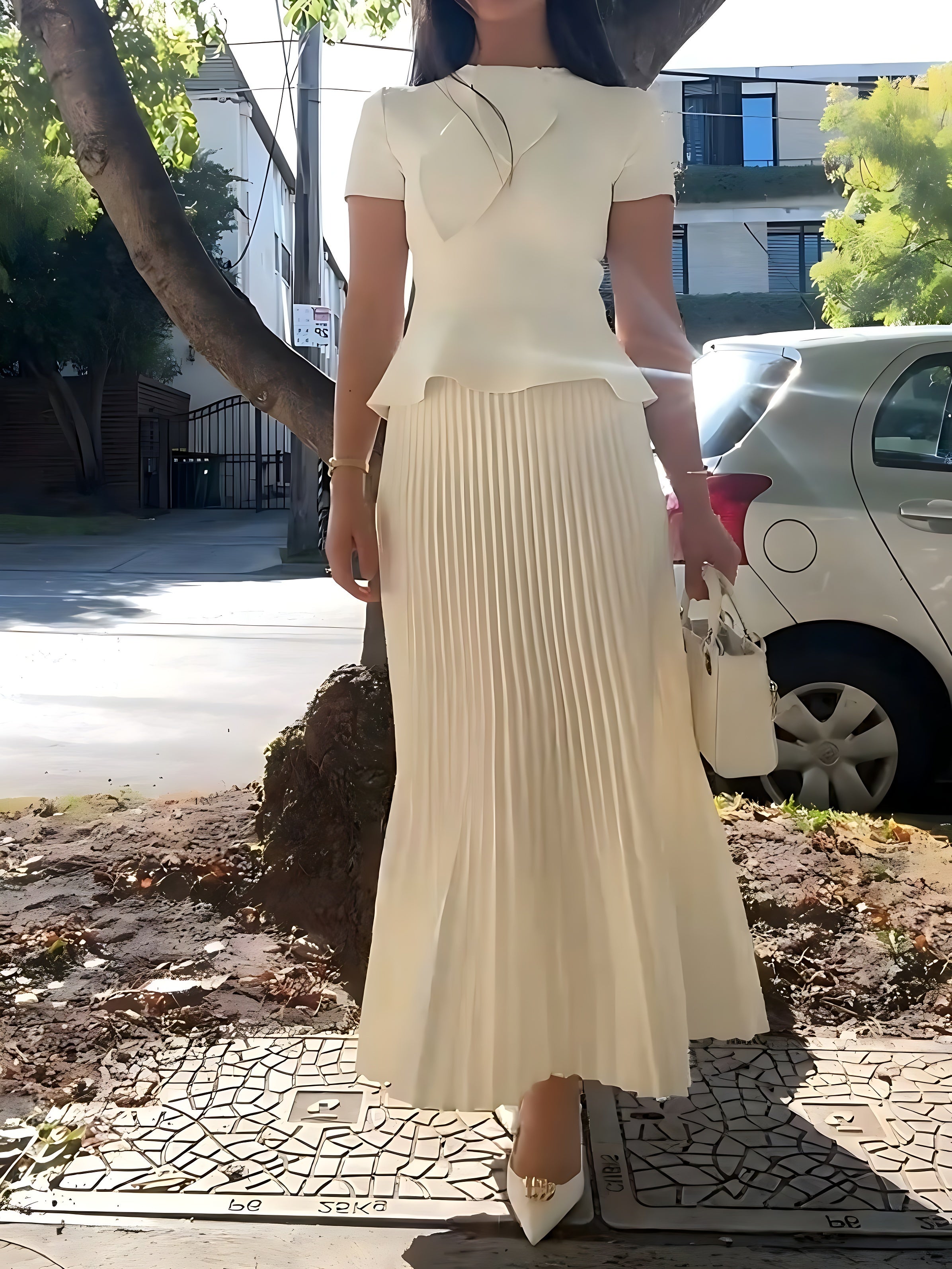 Women's cream crepe knit cravat top and pleated maxi skirt set, front view