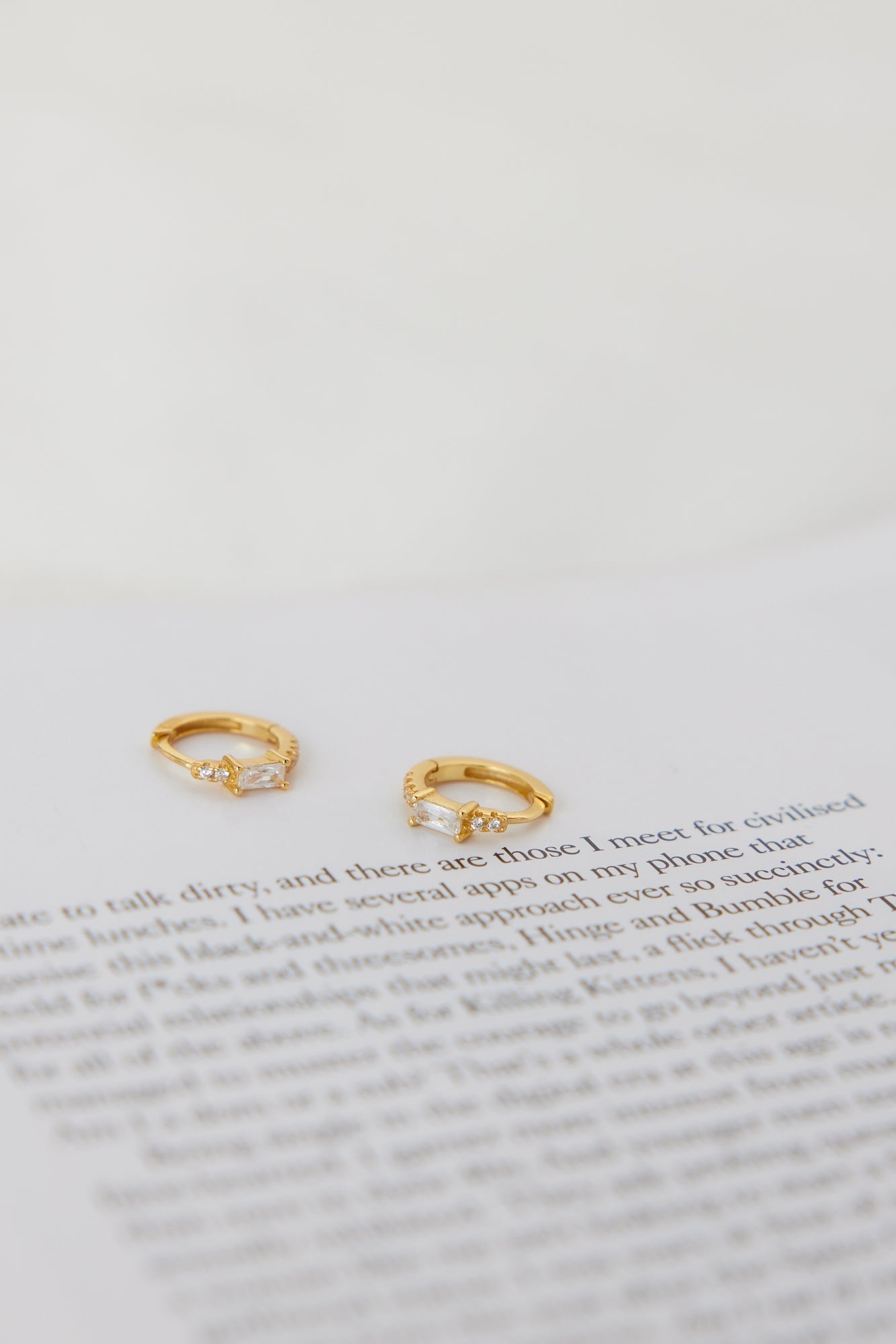Women's gold cubic zirconia hoop earrings — detail shot