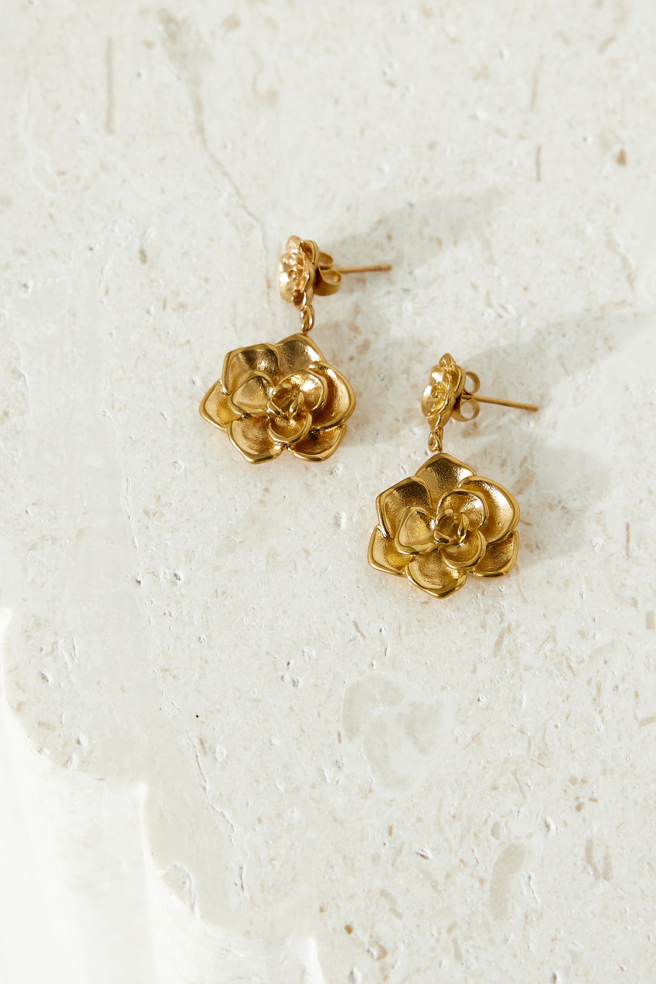 Women's gold double flower earrings — detail shot