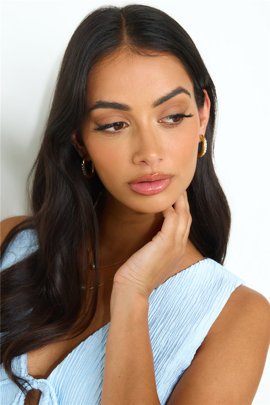Women's gold faux pearl hoop earrings — detail view