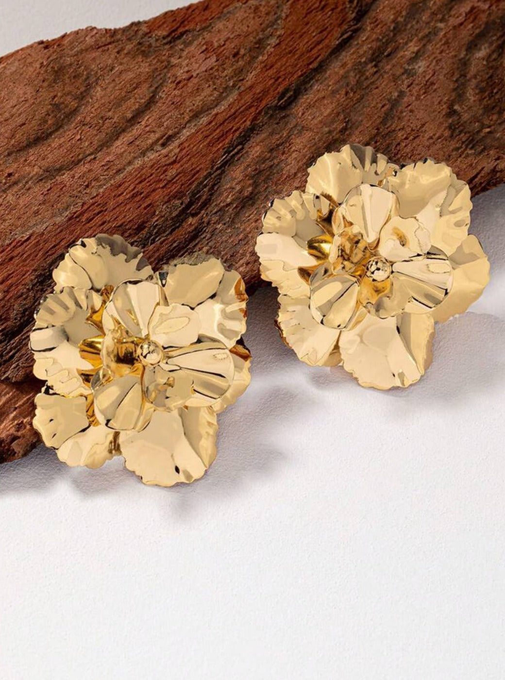 Women's gold flower earrings — alternate angle