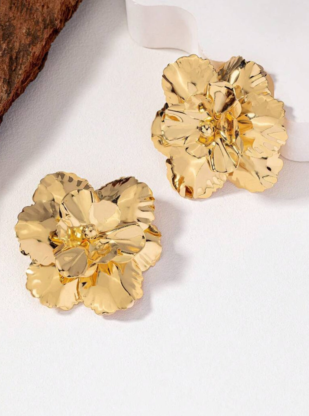 Women's gold flower earrings — detail view
