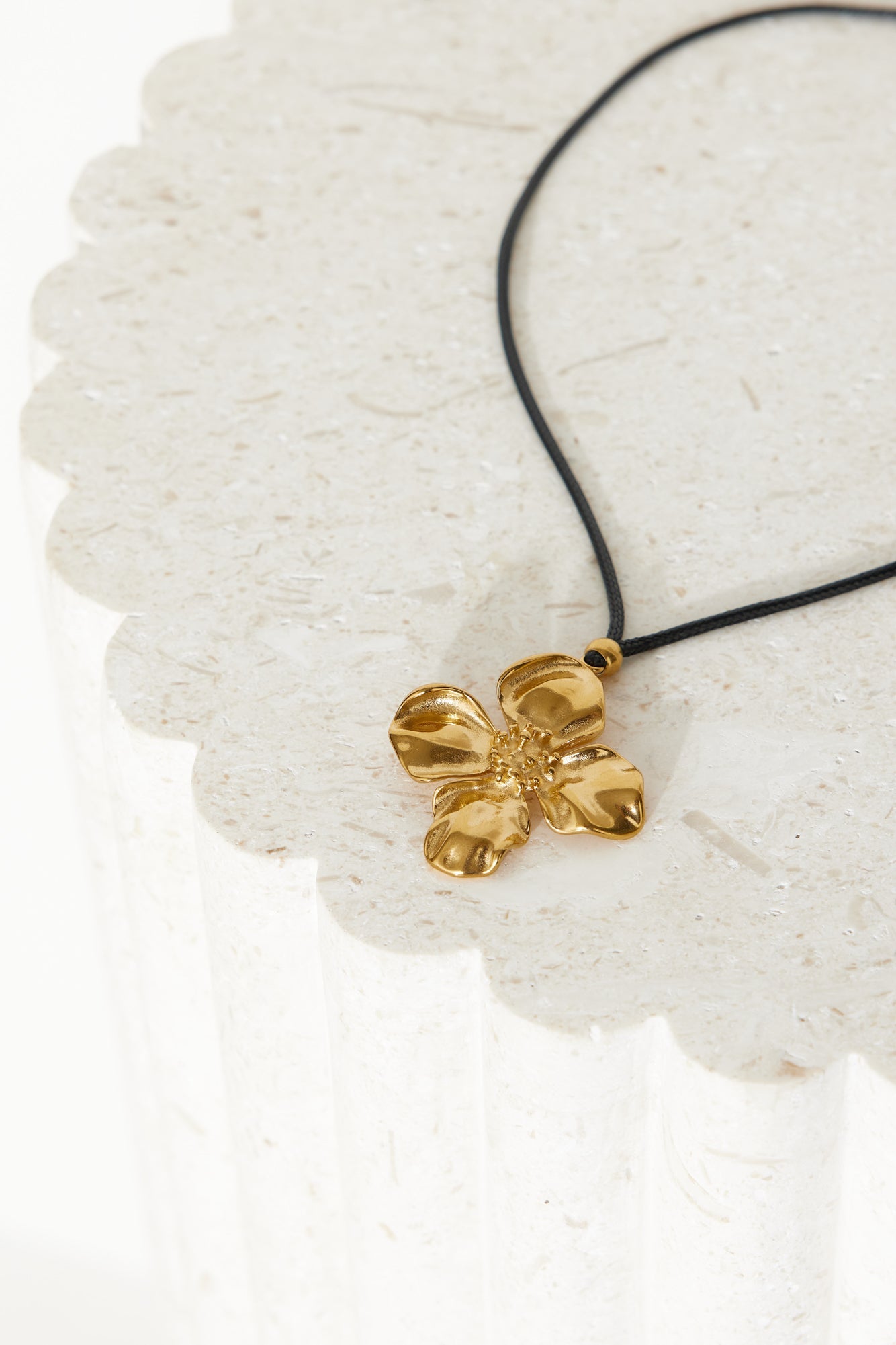 Women's gold flower pendant cord necklace — alternate angle