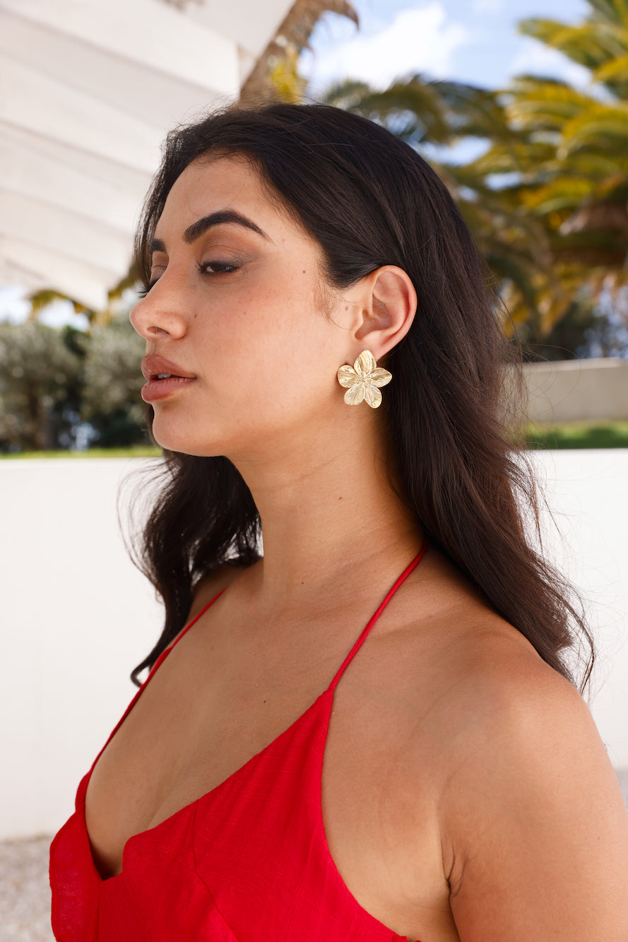 Women's gold flower stud earrings — alternate angle