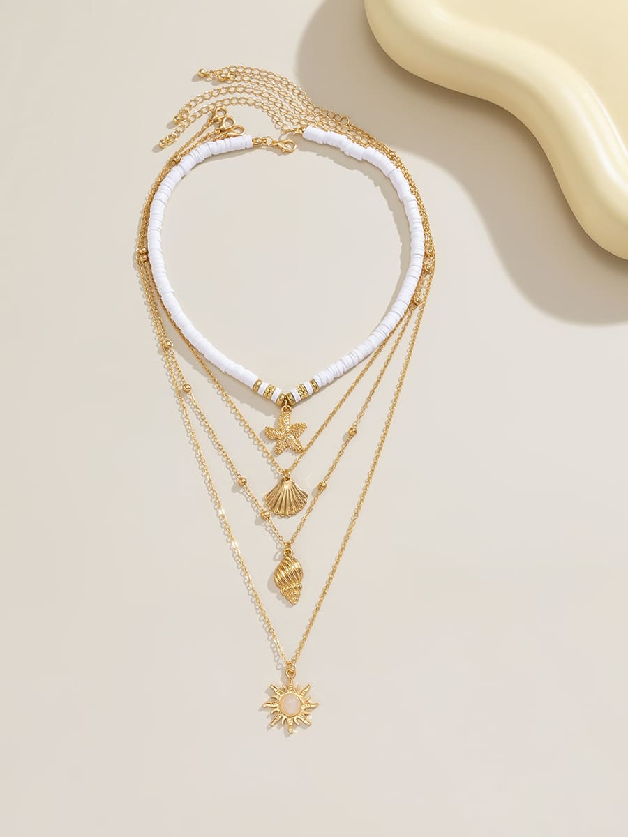 Women's gold layered shell and starfish necklace — side detail