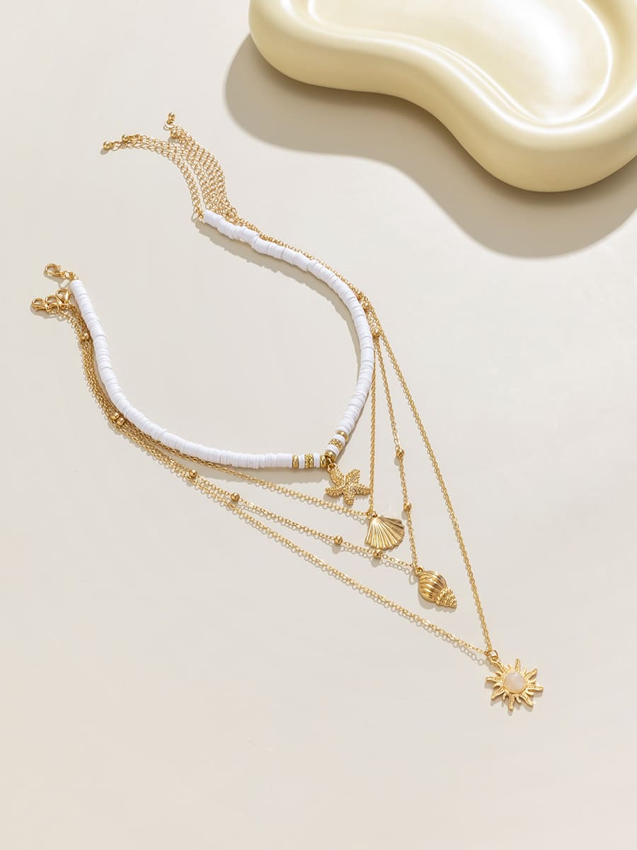 Women's gold layered shell and starfish necklace — alternate angle