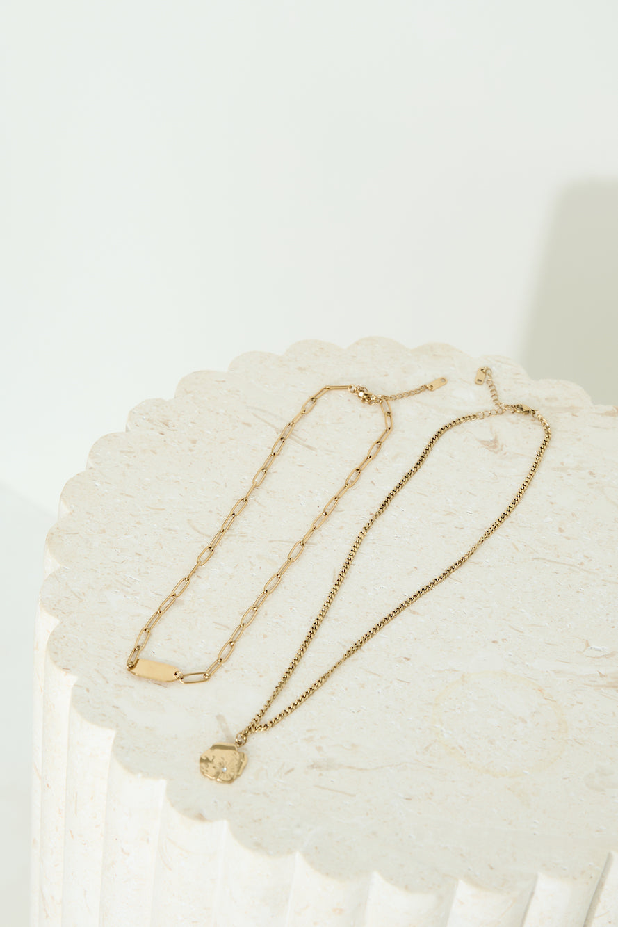 Women's gold-plated layered necklace set — worn detail