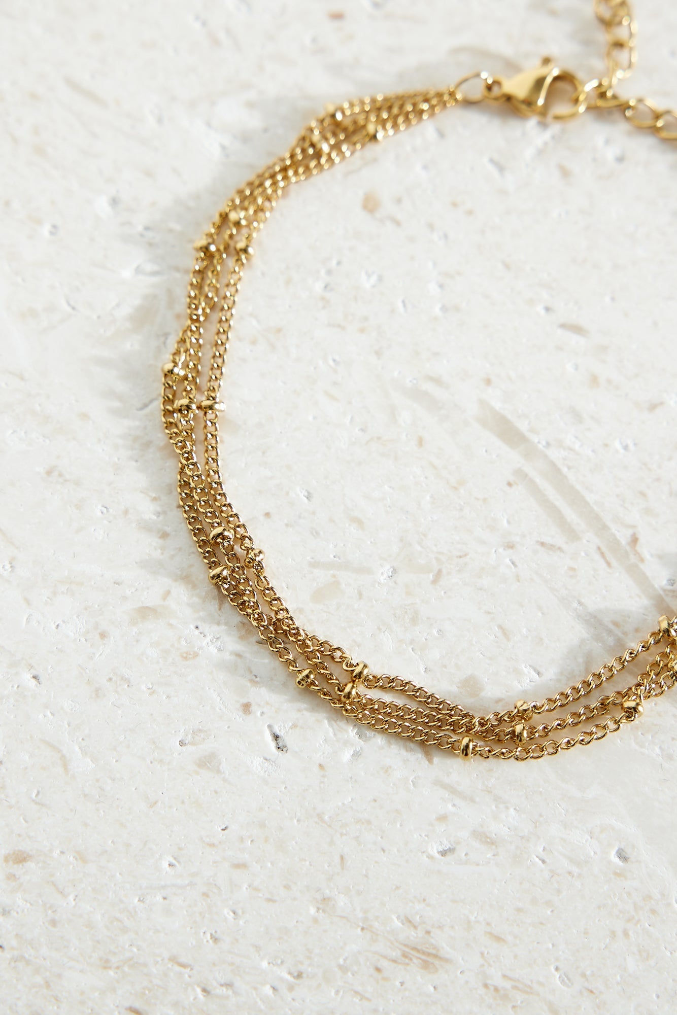 Women's gold-plated triple chain bracelet — alternate angle