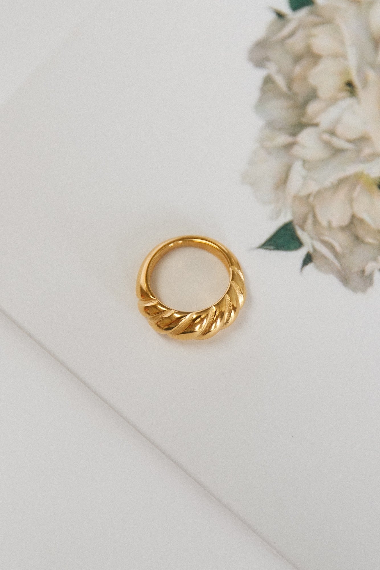 Women's gold-plated twist stacking ring — worn detail