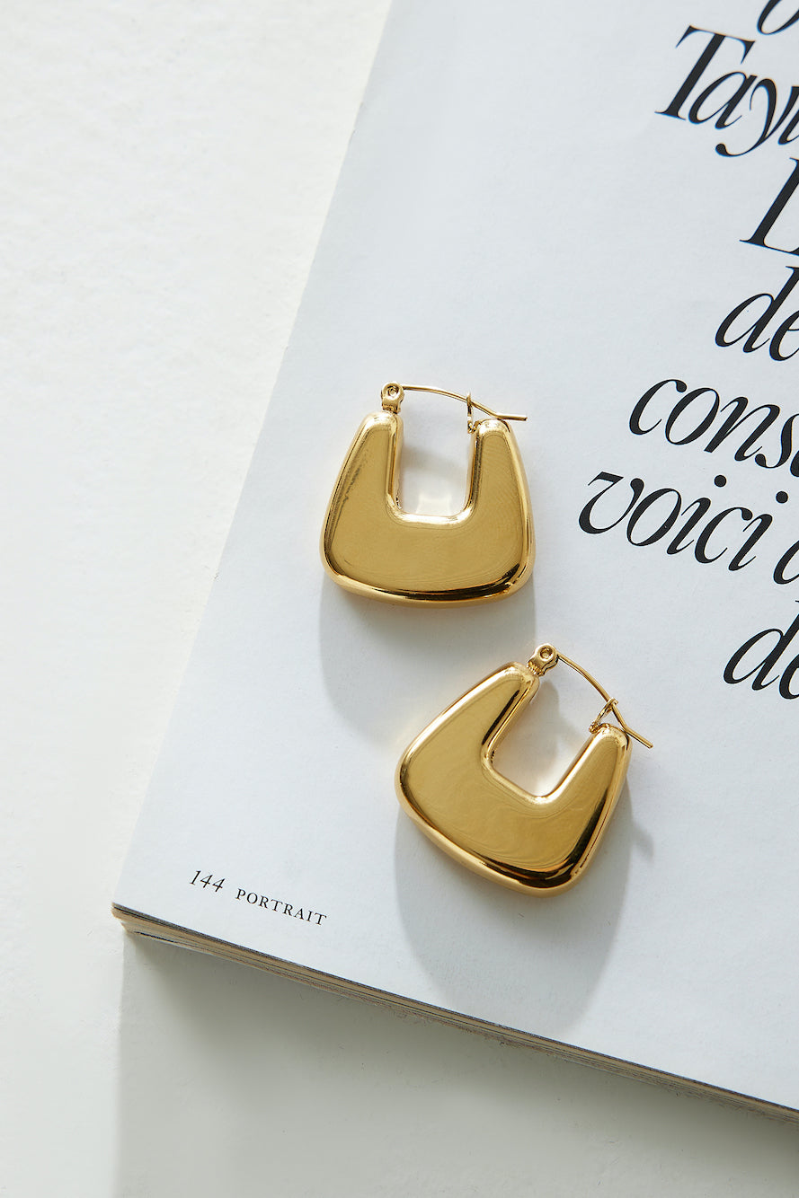 Women's gold polished hoop earrings — alternate angle