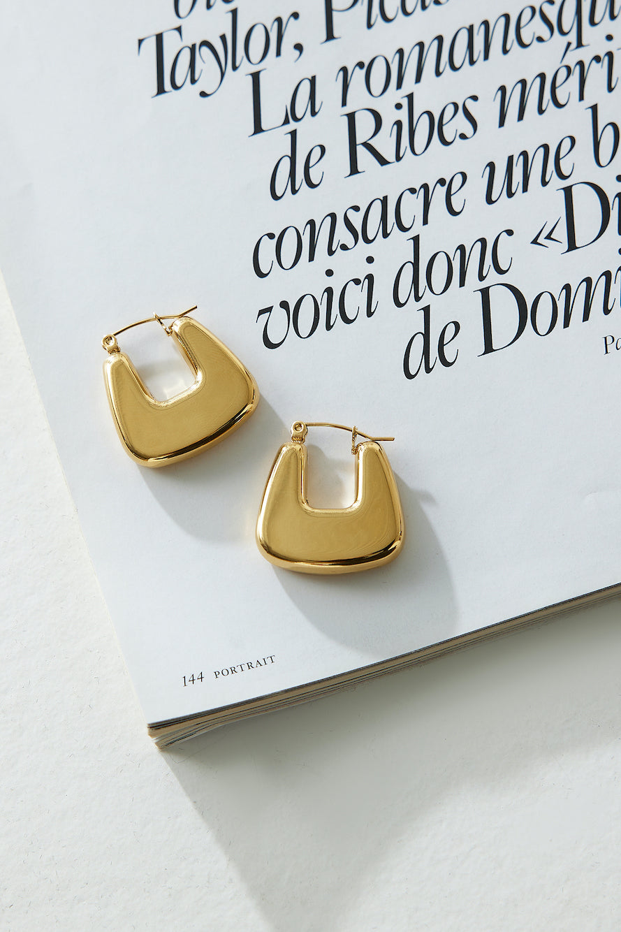 Women's gold polished hoop earrings — alternate angle