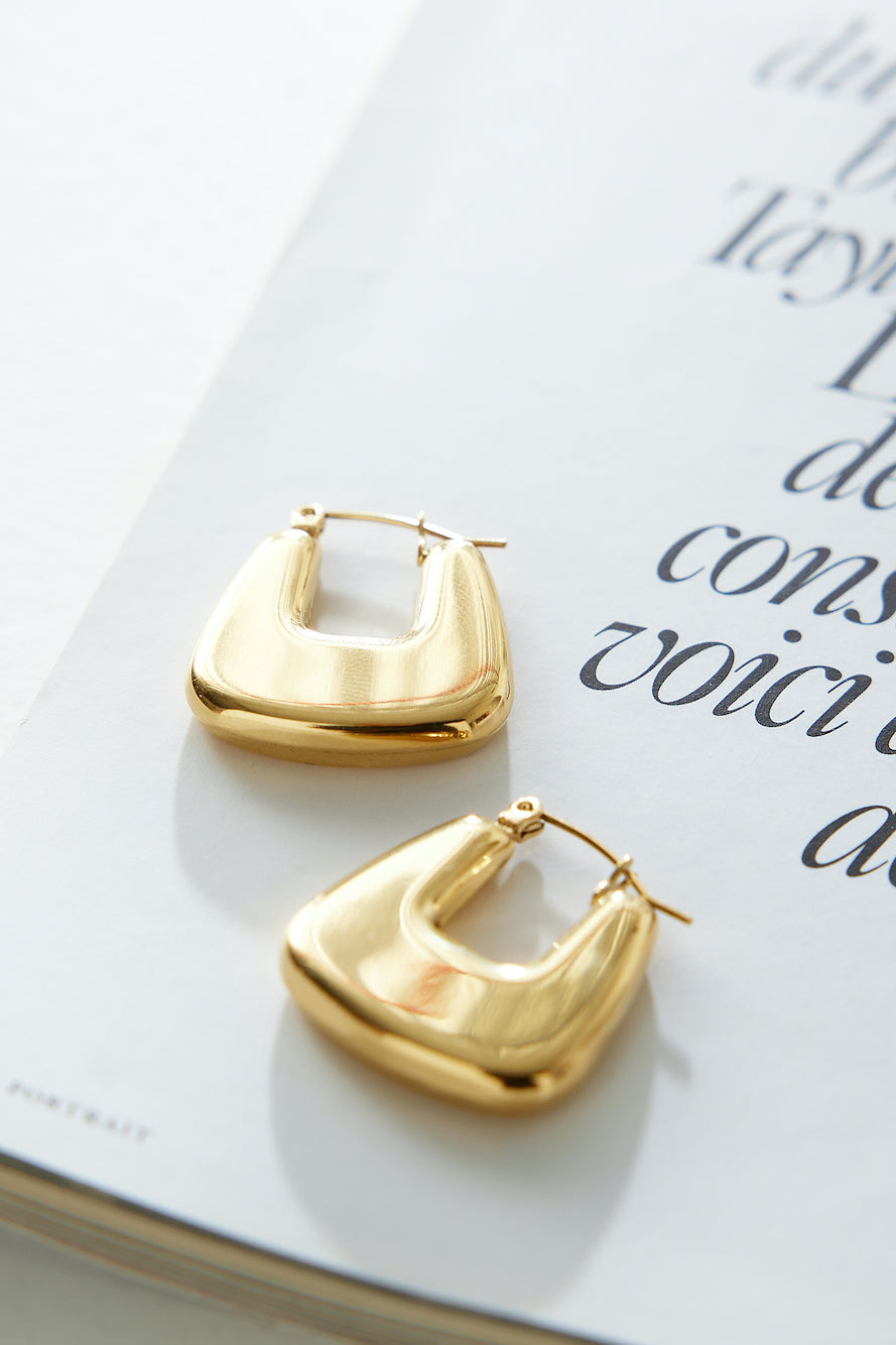 Women's gold polished hoop earrings — alternate angle