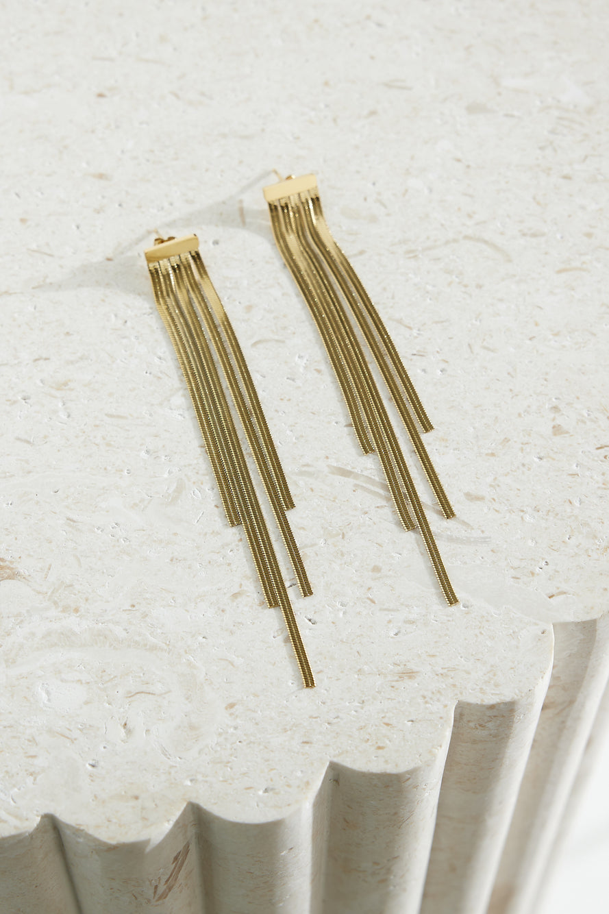 Women's gold snake chain earrings — detail shot