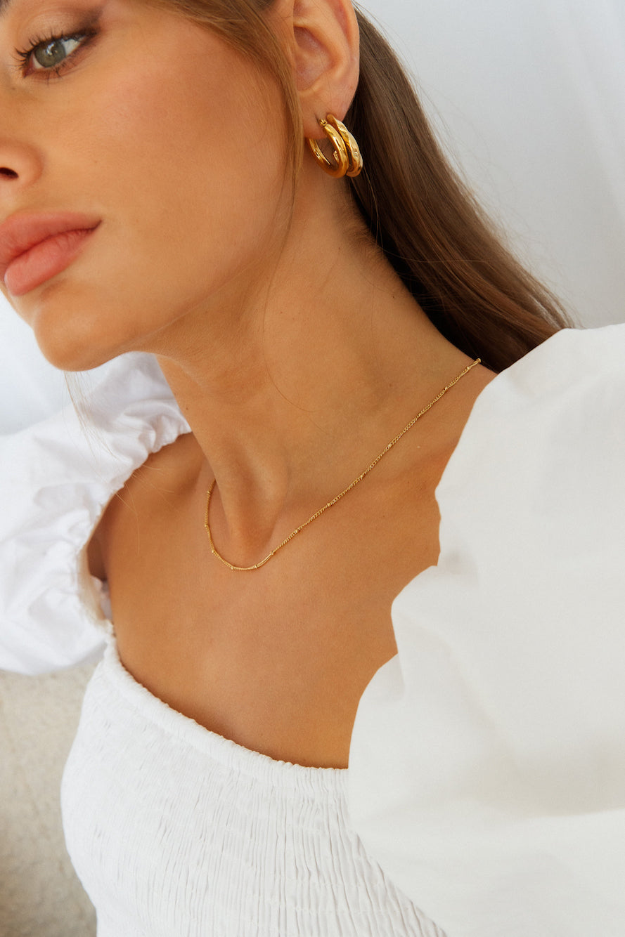 Women's gold staple hoop earrings