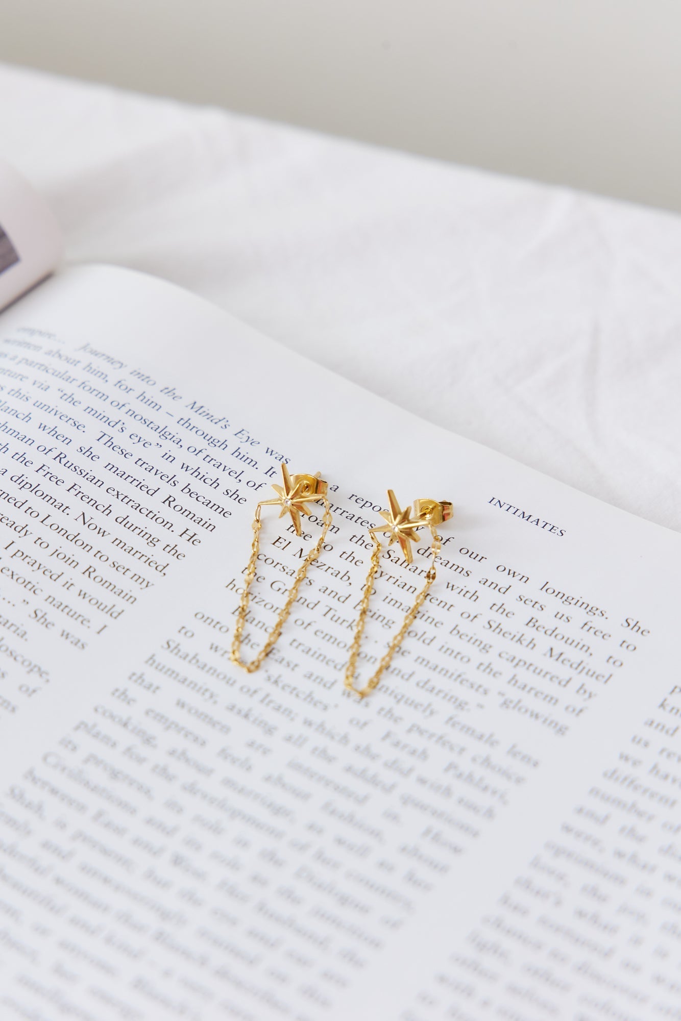 Women's gold star chain drop earrings — detail view