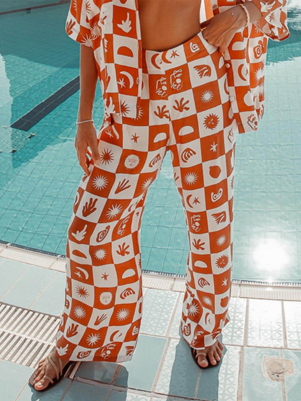 Women's orange tropical print wide-leg trousers — fabric detail