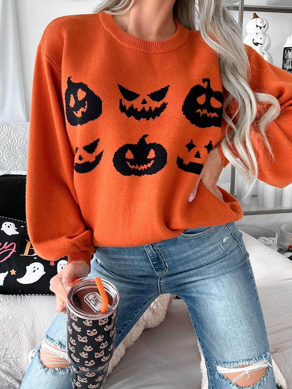 Women's orange pumpkin carving knit Halloween sweater — side detail