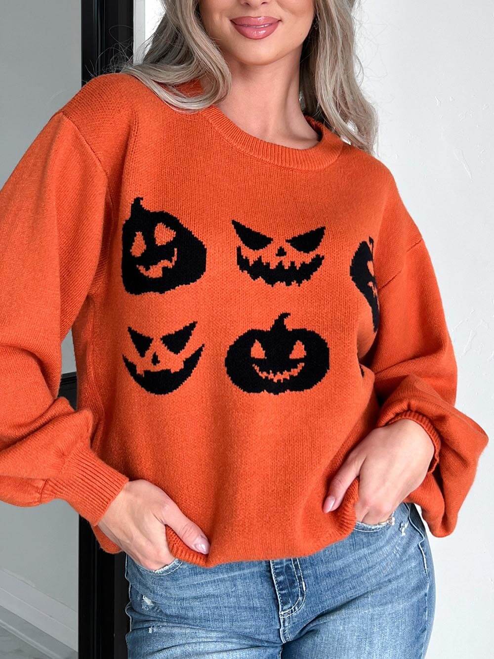 Women's orange pumpkin carving knit Halloween sweater — full length